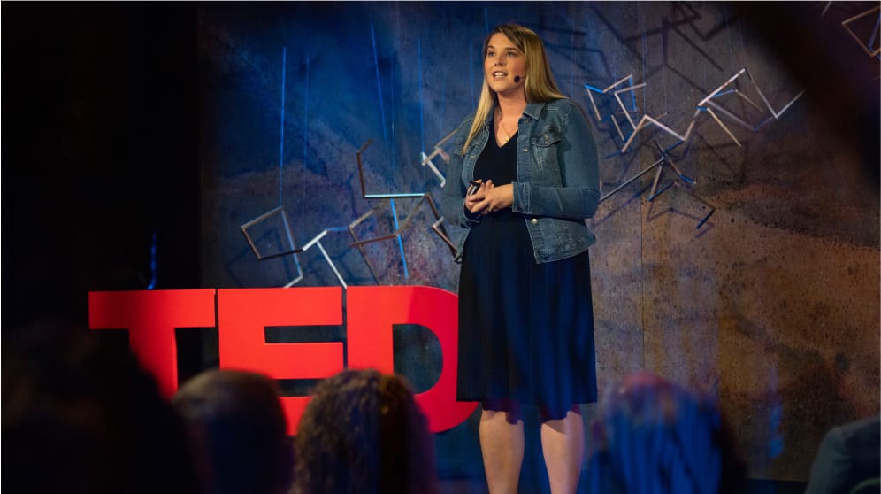 A presenter giving a TED talk