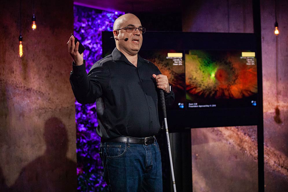 A presenter with hand raised while speaking