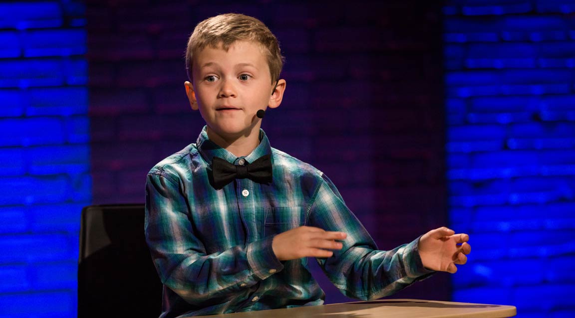 A boy presenting an idea with hands in a waving gesture